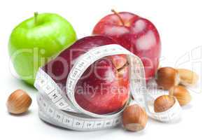 apple, nuts  and measure  tape isolated on white