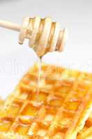 delicious Belgian waffles and stick to honey isolated on white