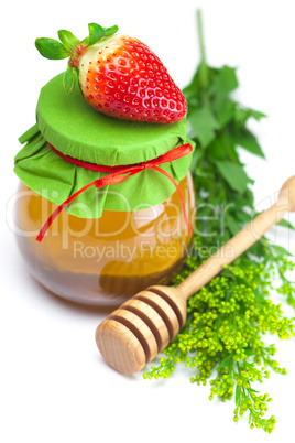 stick to hohey,strawberries  and  jar of honey  isolated on whit
