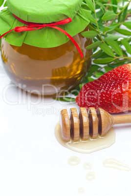 stick to hohey and  jar of honey  isolated on white