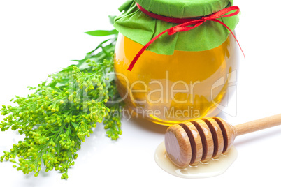 stick to hohey and  jar of honey  isolated on white