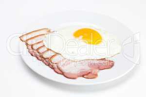 bacon and fried eggs on a plate isolated on white