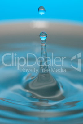 water drop and splash on a blue background