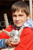 Teenage boy with little goat