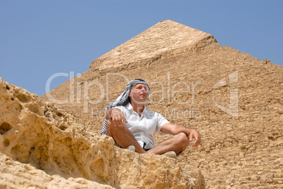 Man tourist by pyramid in Egypt