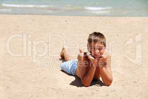 Boy lying on the beach
