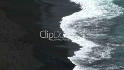 el golfo waves on black lava beach background