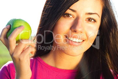 portrait of a beautiful young woman with apple  outdoor