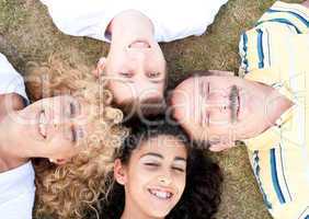 Happy family of four on grass