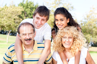 Parents giving kids piggy back ride