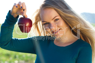 portrait of a beautiful young woman with apple  outdoor