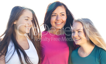 portret of three young beautiful woman on the  sky background