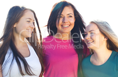 portret of three young beautiful woman on the  sky background