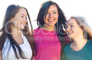 portret of three young beautiful woman on the  sky background