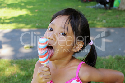 Little Asian Girl Licking Popsicle