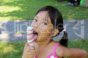 Little Asian Girl Licking Popsicle