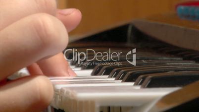 child play at toy piano