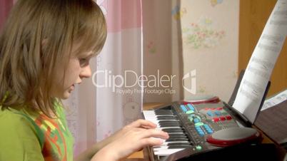 child play at toy piano