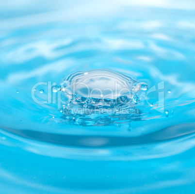 water drop and splash on a blue background