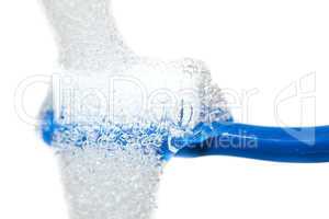 blue toothbrush under running water