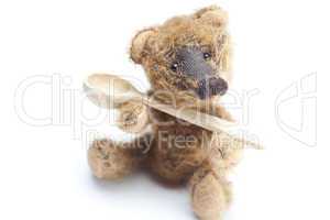 Teddy Bear and a wooden spoon isolated on white