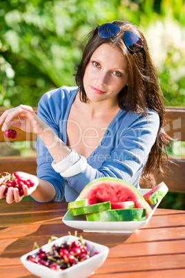 Fresh cherries melon woman garden summer terrace