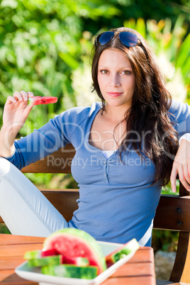 Eating fresh melon beautiful young woman bench