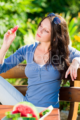 Eating fresh melon beautiful young woman bench