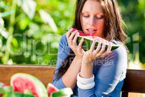 Eating fresh melon beautiful young woman bench