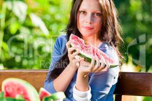 Eating fresh melon beautiful young woman bench