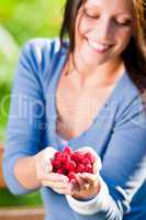 Fresh raspberries hold hand cheerful smiling woman
