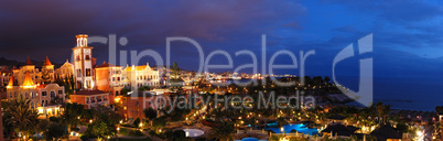 Night illumination of luxury hotel during sunset and Playa de la