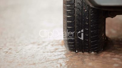 car tire in a stream of of rainwater