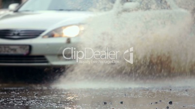 car splashes on flooded street