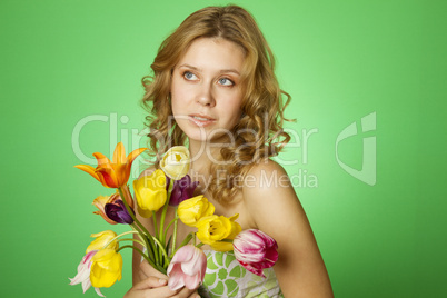 Happy Young Woman hugging a bouquet of tulips