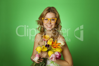 Happy Young Woman hugging a bouquet of tulips