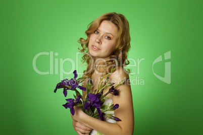 Attractive girl hugging a bouquet of iris