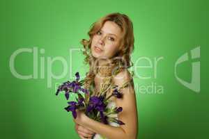 Attractive girl hugging a bouquet of iris