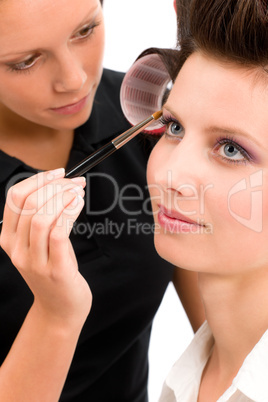 Make-up artist woman fashion model apply eyeshadow