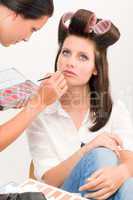 Make-up artist woman fashion model apply lipstick