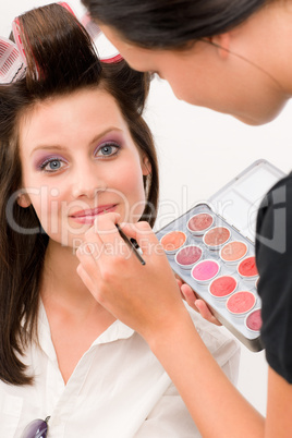 Make-up artist woman fashion model apply lipstick