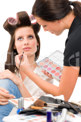 Make-up artist woman fashion model apply lipstick