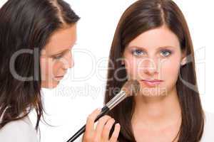 Make-up artist woman fashion model apply powder
