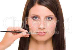 Professional makeup model woman apply  lipstick