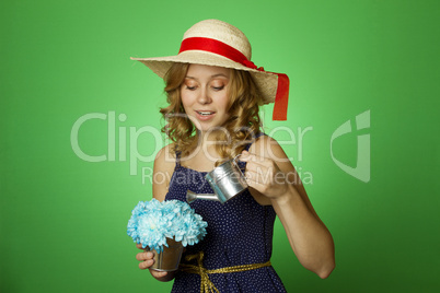 Attractive girl watering flowers