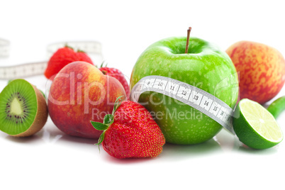 big juicy red ripe strawberries,apple,lime,peach,kiwi  and measu