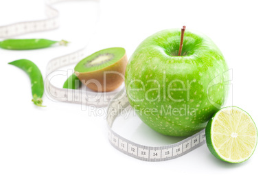 apple,lime,peas,kiwi and measure tape isolated on white