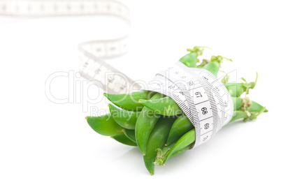 peas and measure tape isolated on white