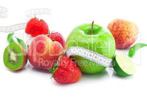 big juicy red ripe strawberries,apple,lime,peach,kiwi  and measu