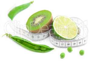 lime,peas,kiwi and measure tape isolated on white